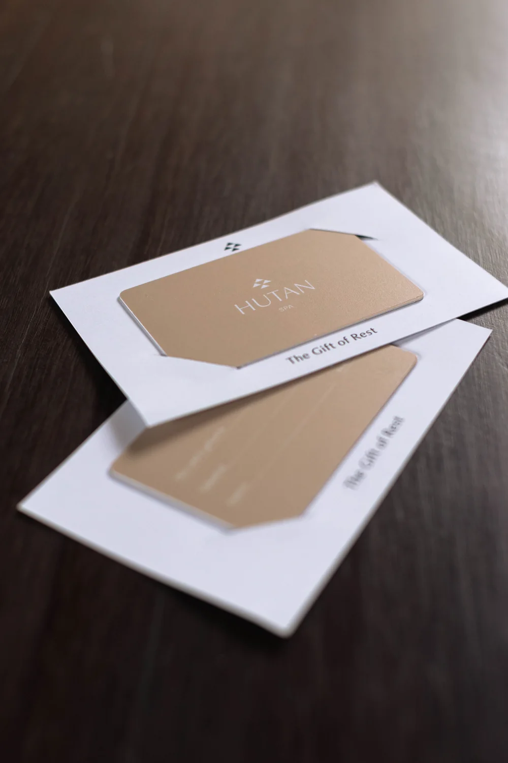 Two linen-coloured Hutan Spa gift cards reading ‘The Gift of Rest’